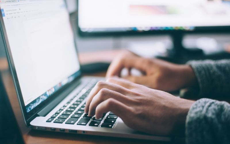 Typing on a laptop